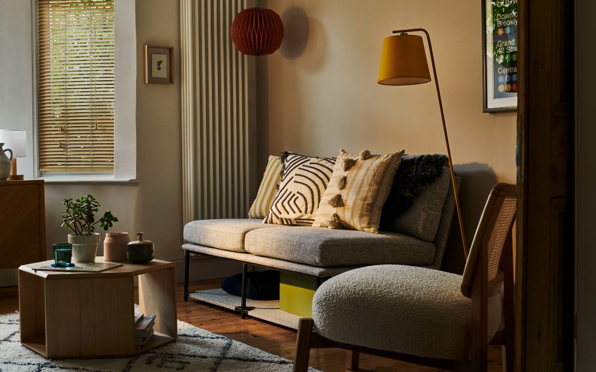 sofa, armchair, bookshelf, framed orange artwork, coffee table