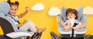 Two children sitting happily in their car seats