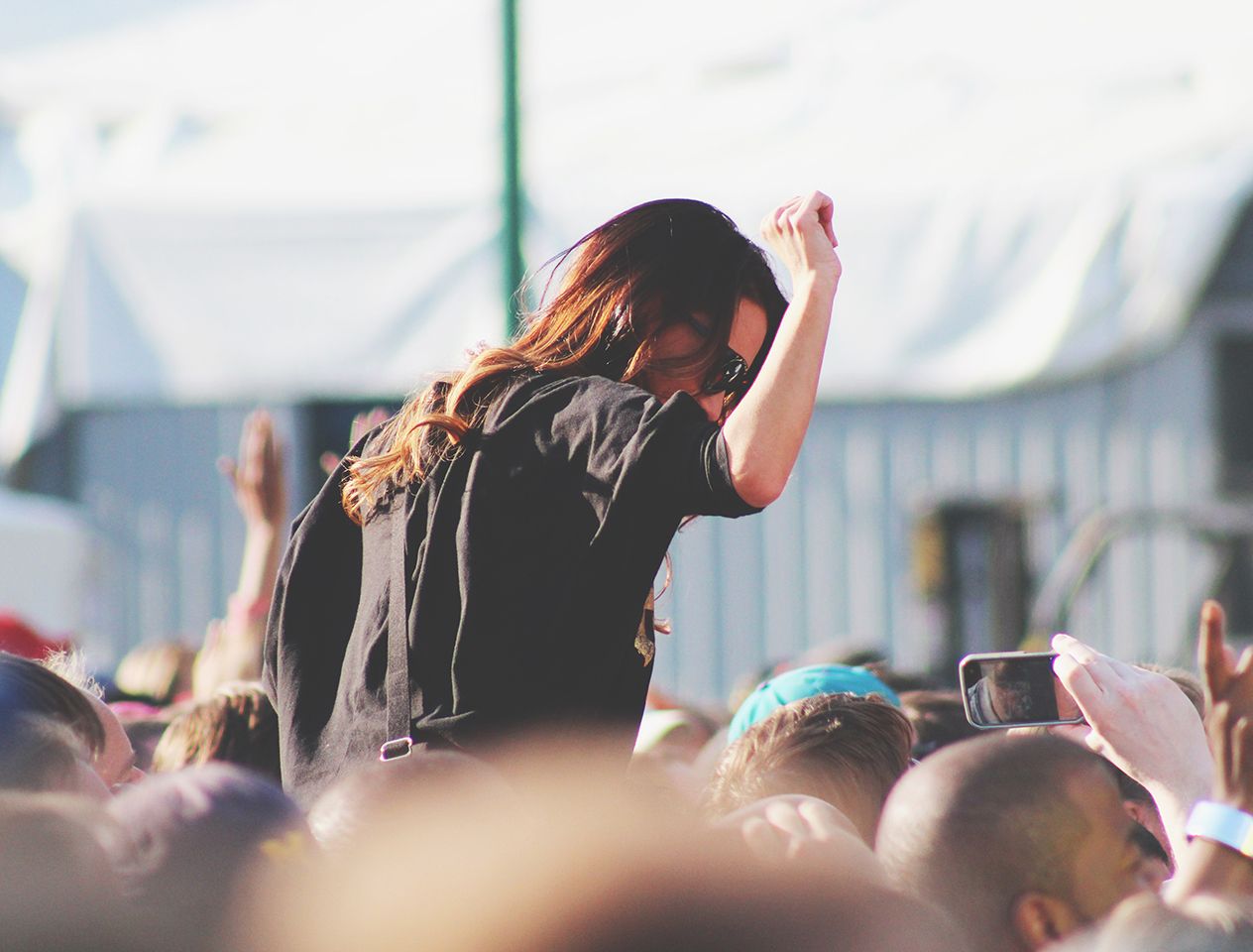 Woman on shoulders at a festival