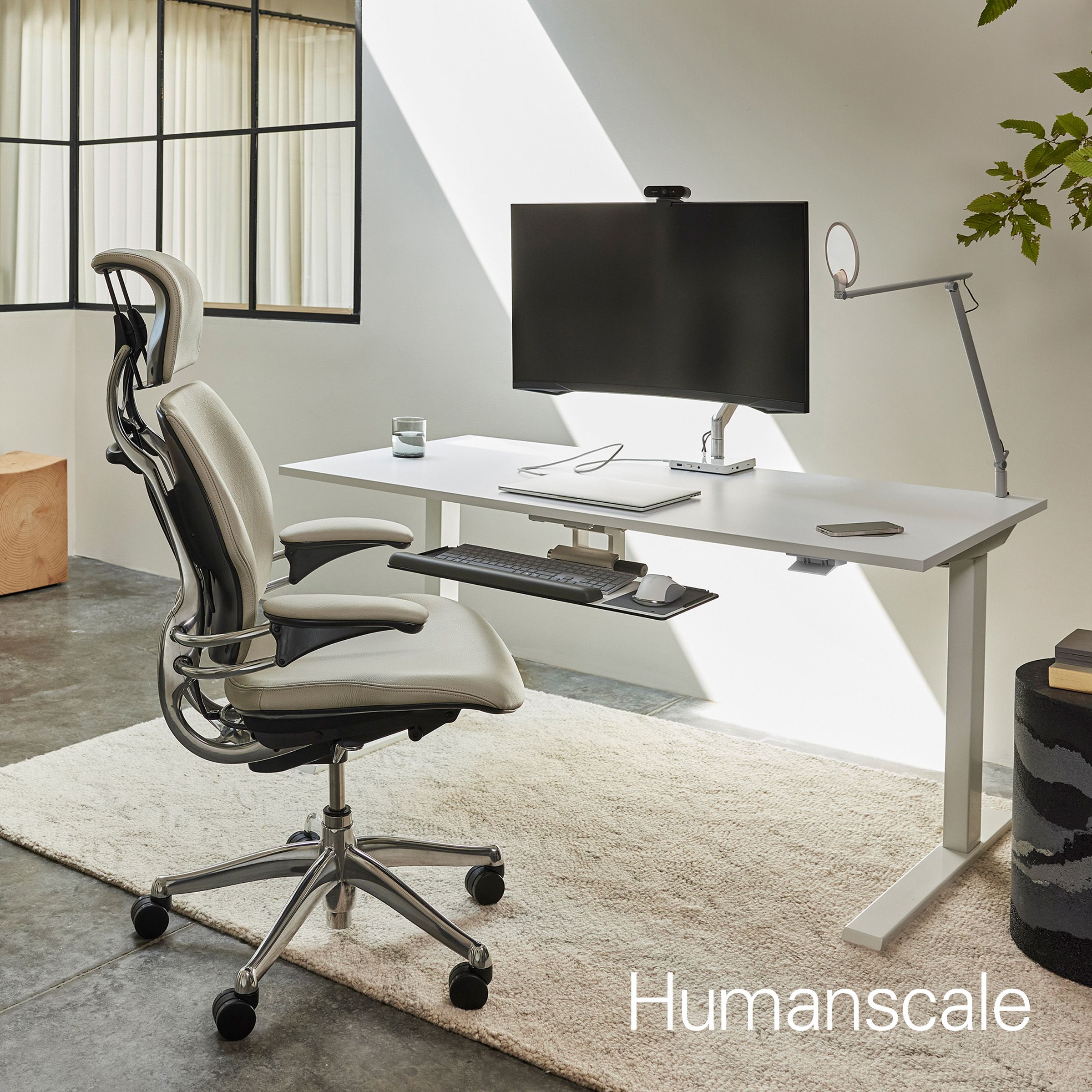 Product shot of Humanscale chair in front of desk