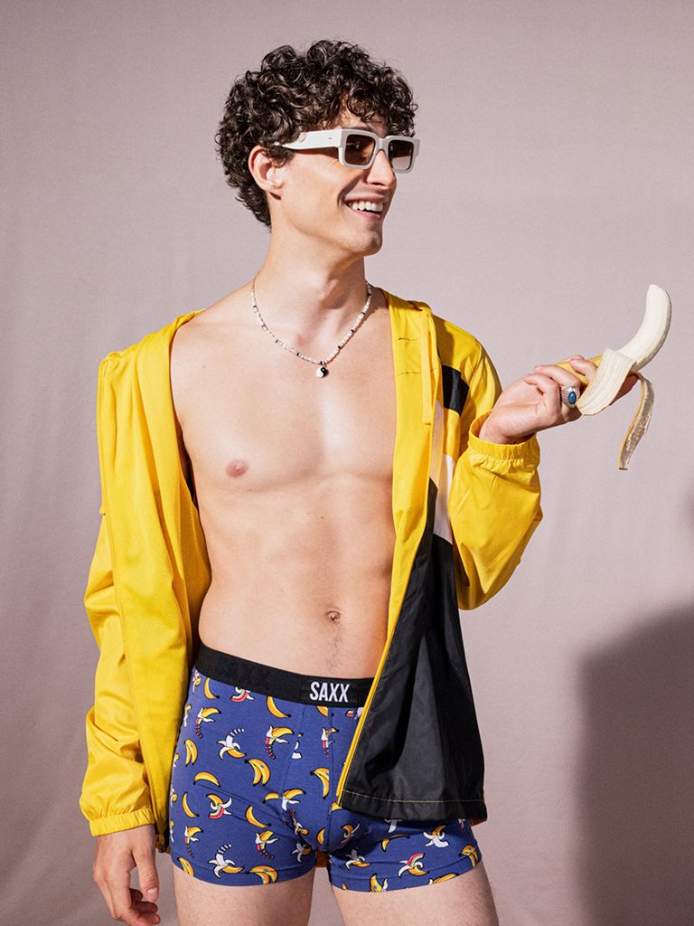 Saxx underwear on man holding banana