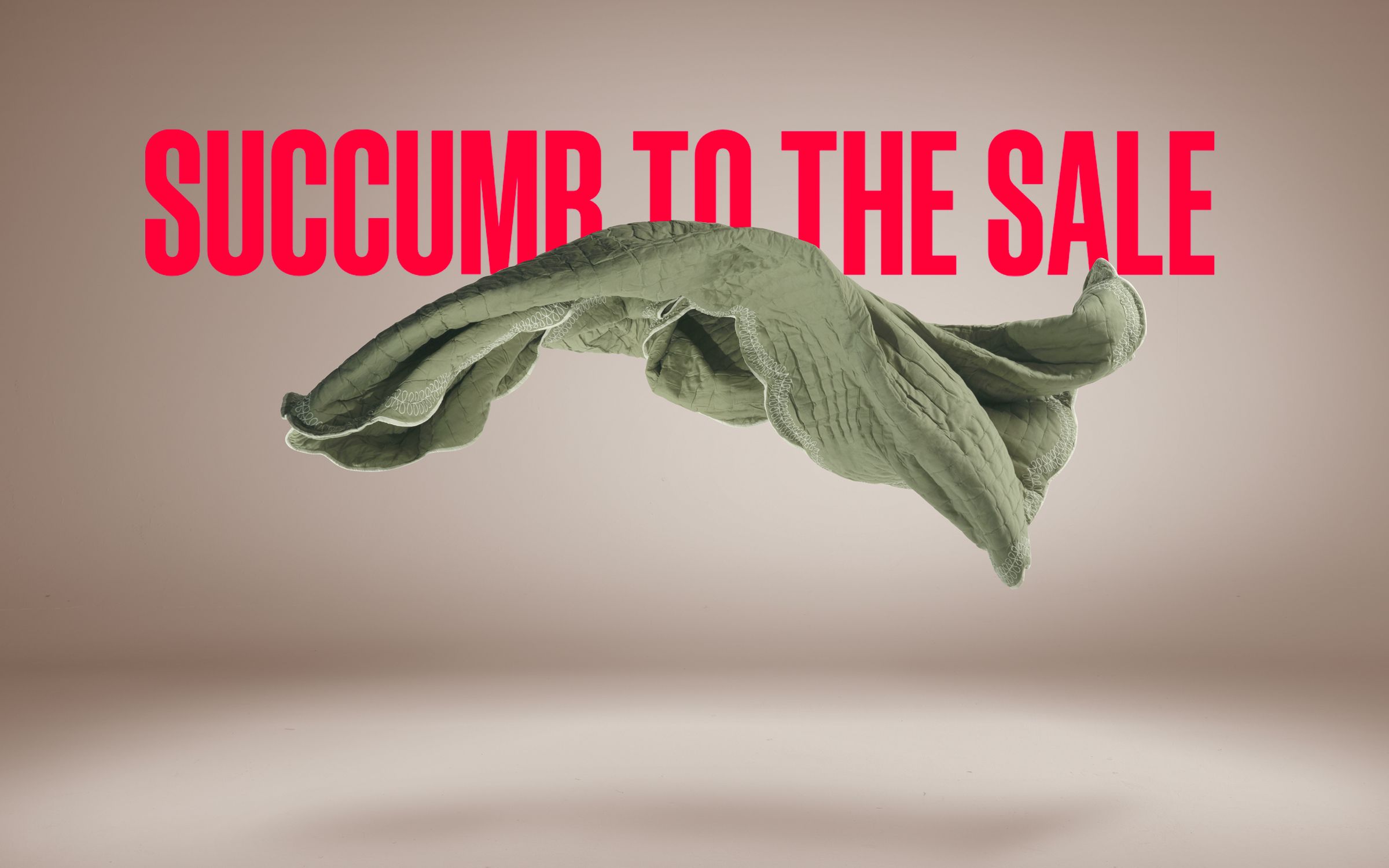 Image of a bed linen being thrown up in the air with the words 'Succumb to the Sale' behind it
