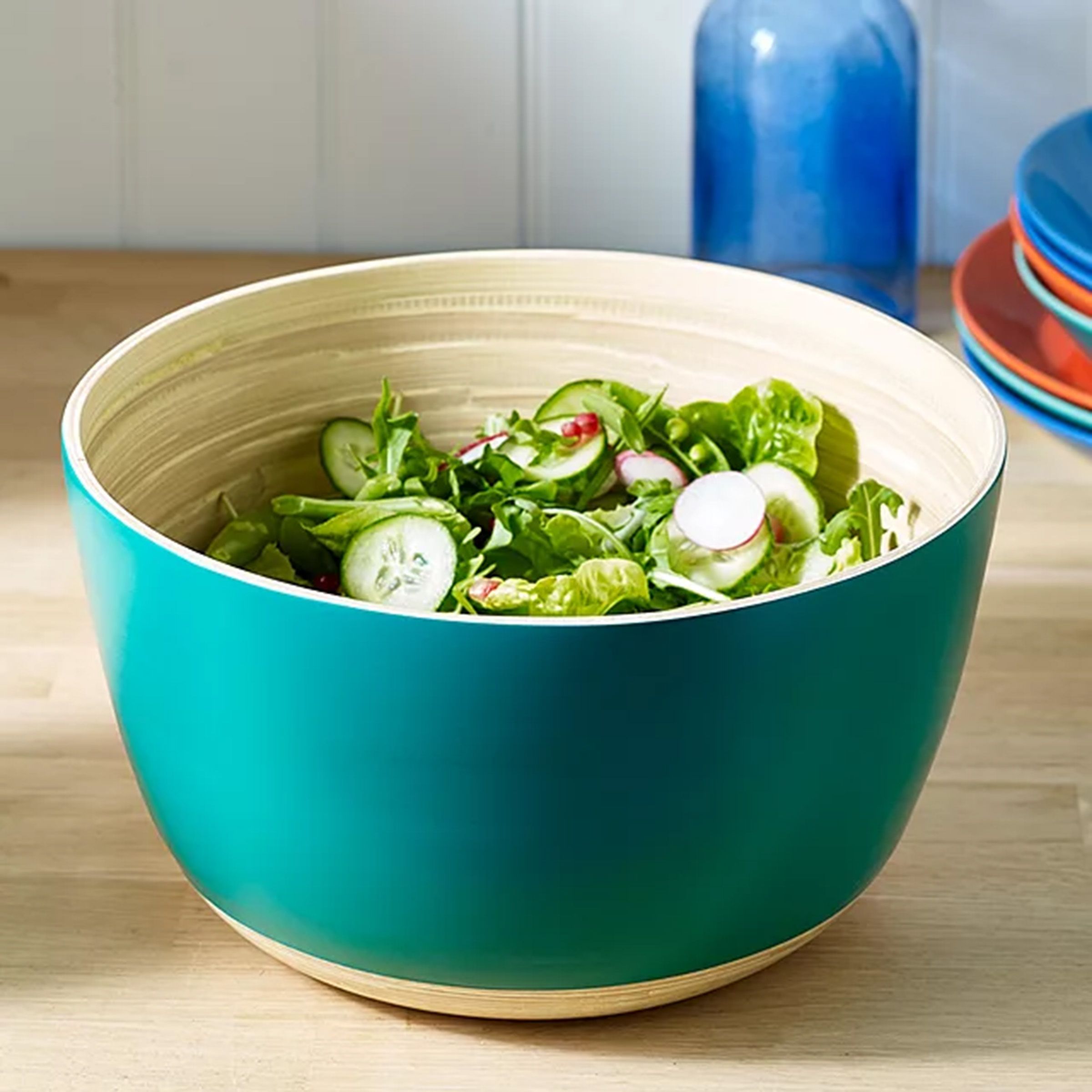 Blue salad bowl with salad in.