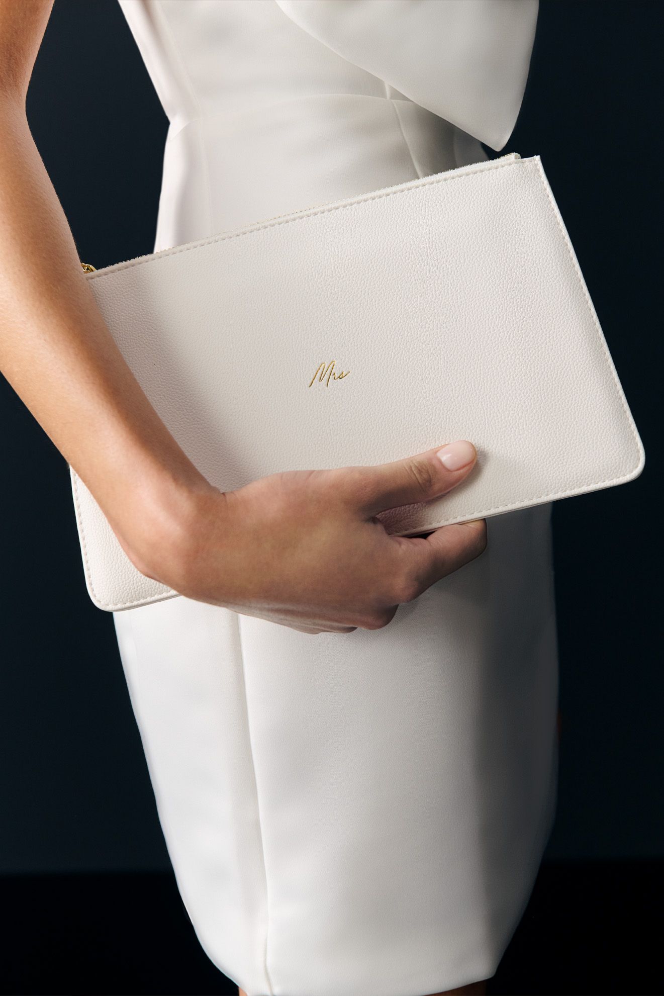 women holding a white handbag