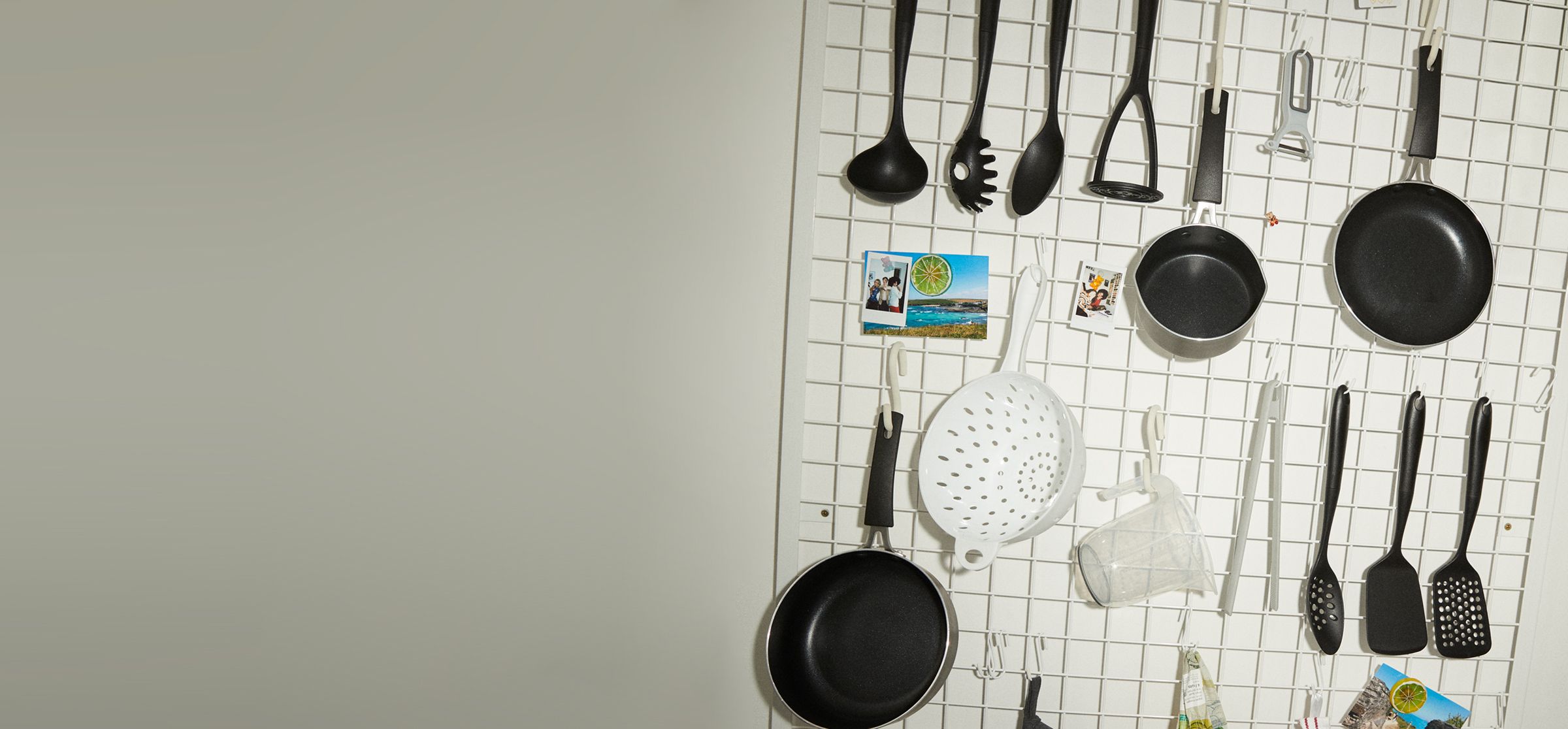 Image of lots of kitchen utensils hanging on a wall