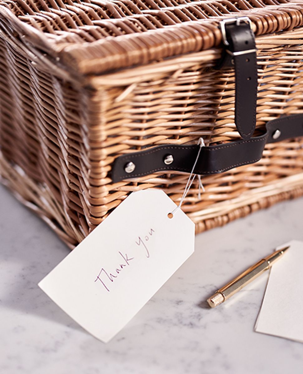 Close up photograph  of a closed hamper gift set and handwritten thank you card
