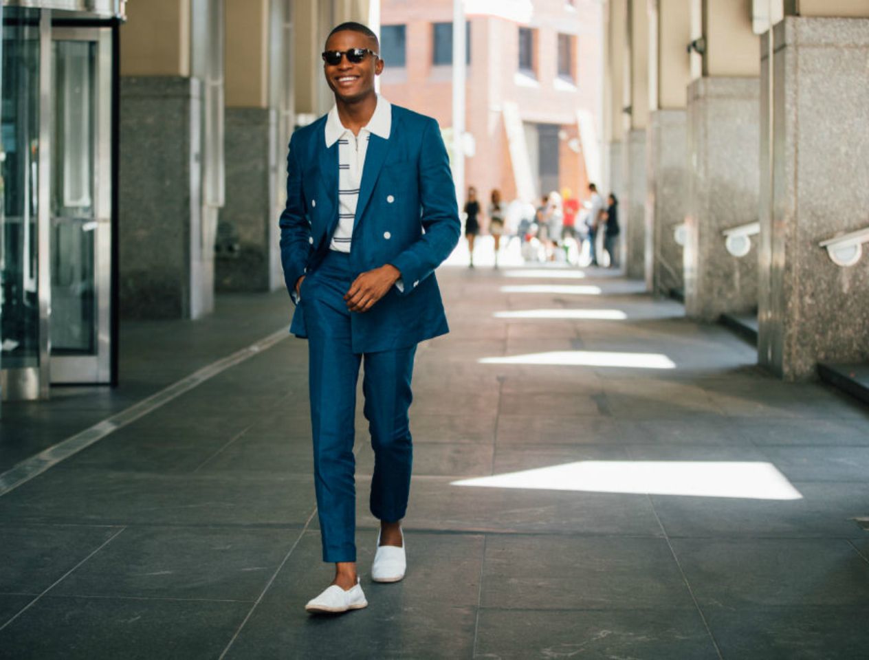 Street style man wearing blue suit and striped polo shirt