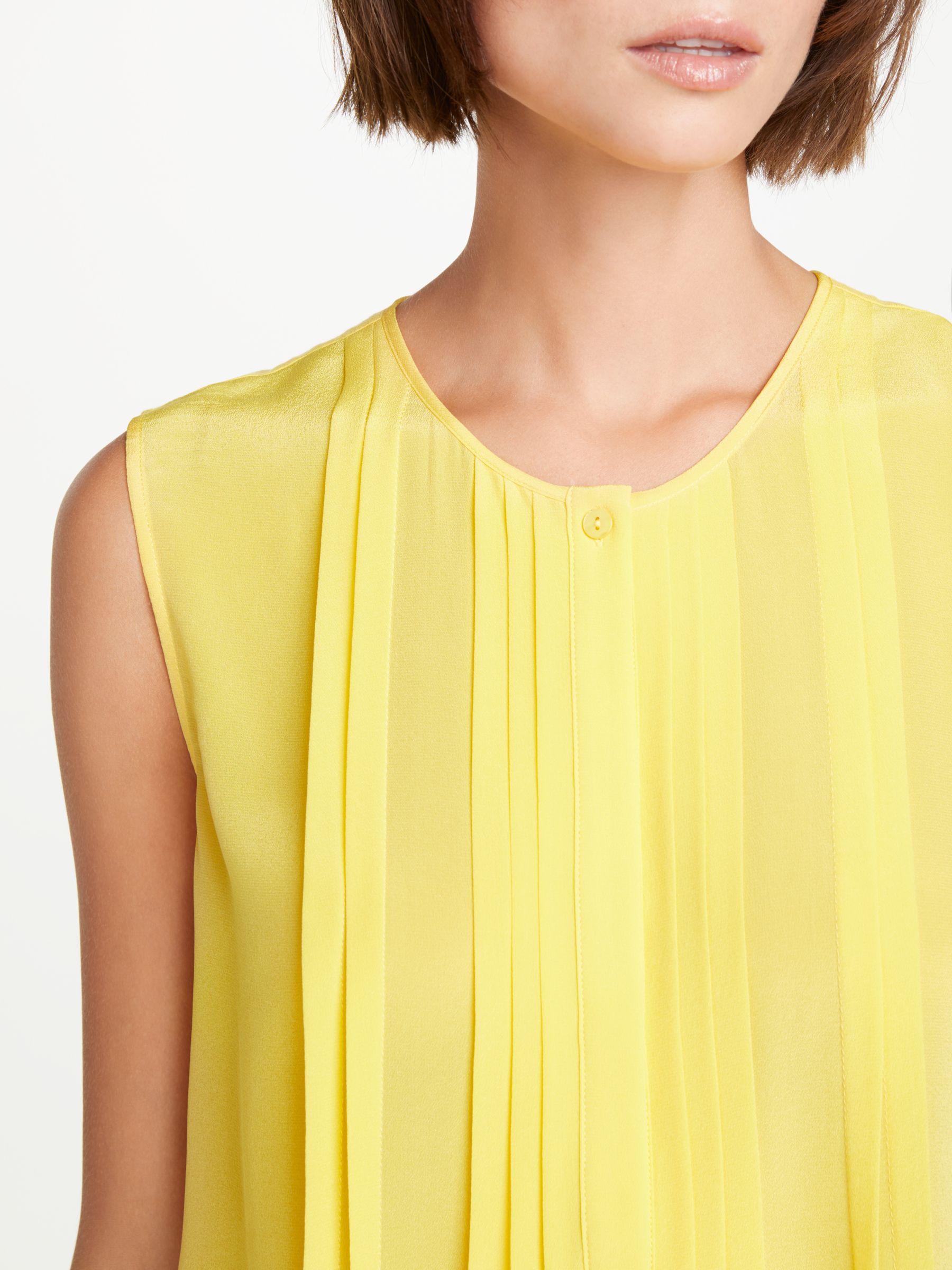 sleeveless yellow blouse