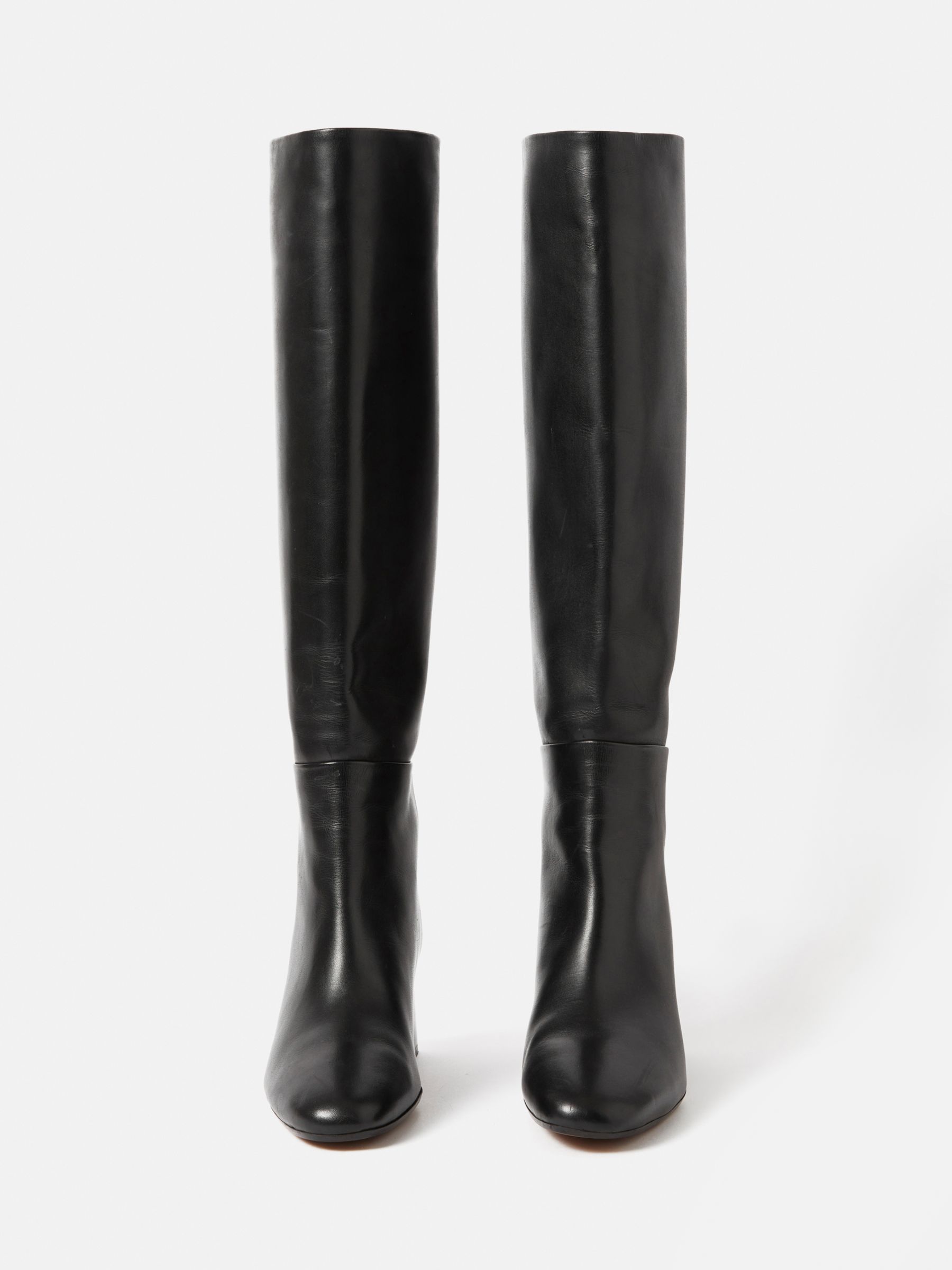 black trousers wearing black leather knee length riding boots - Playground