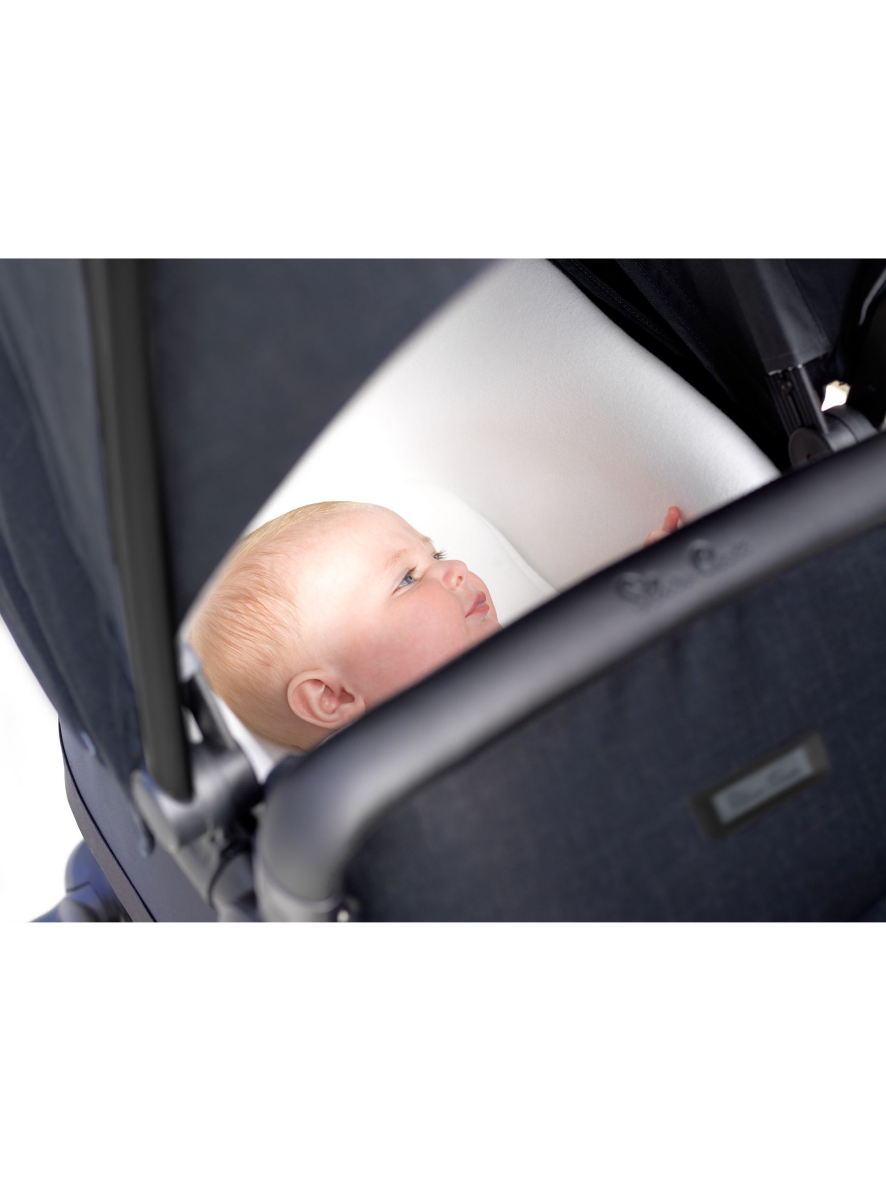 baby sleeping in pram bassinet