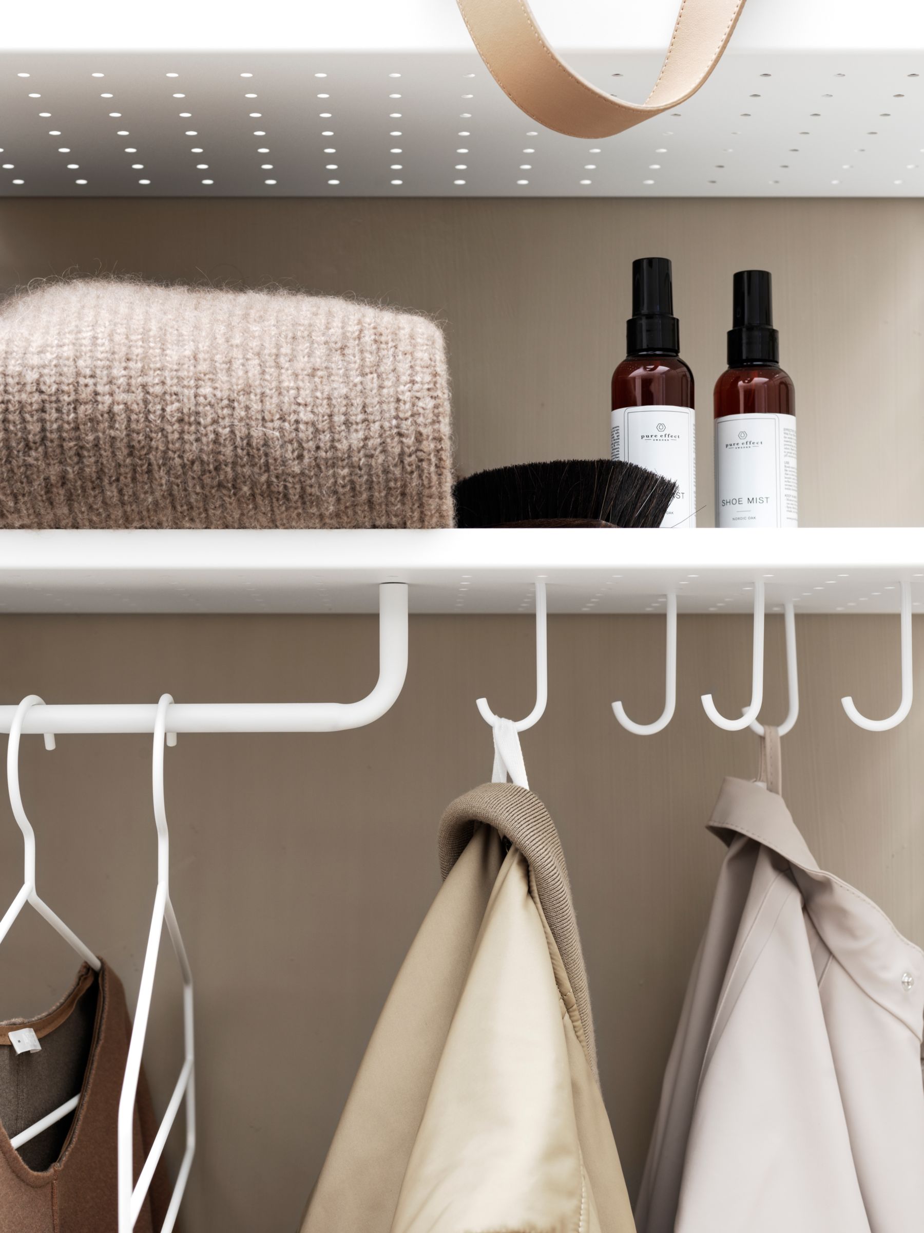 white bathroom shelf with hooks