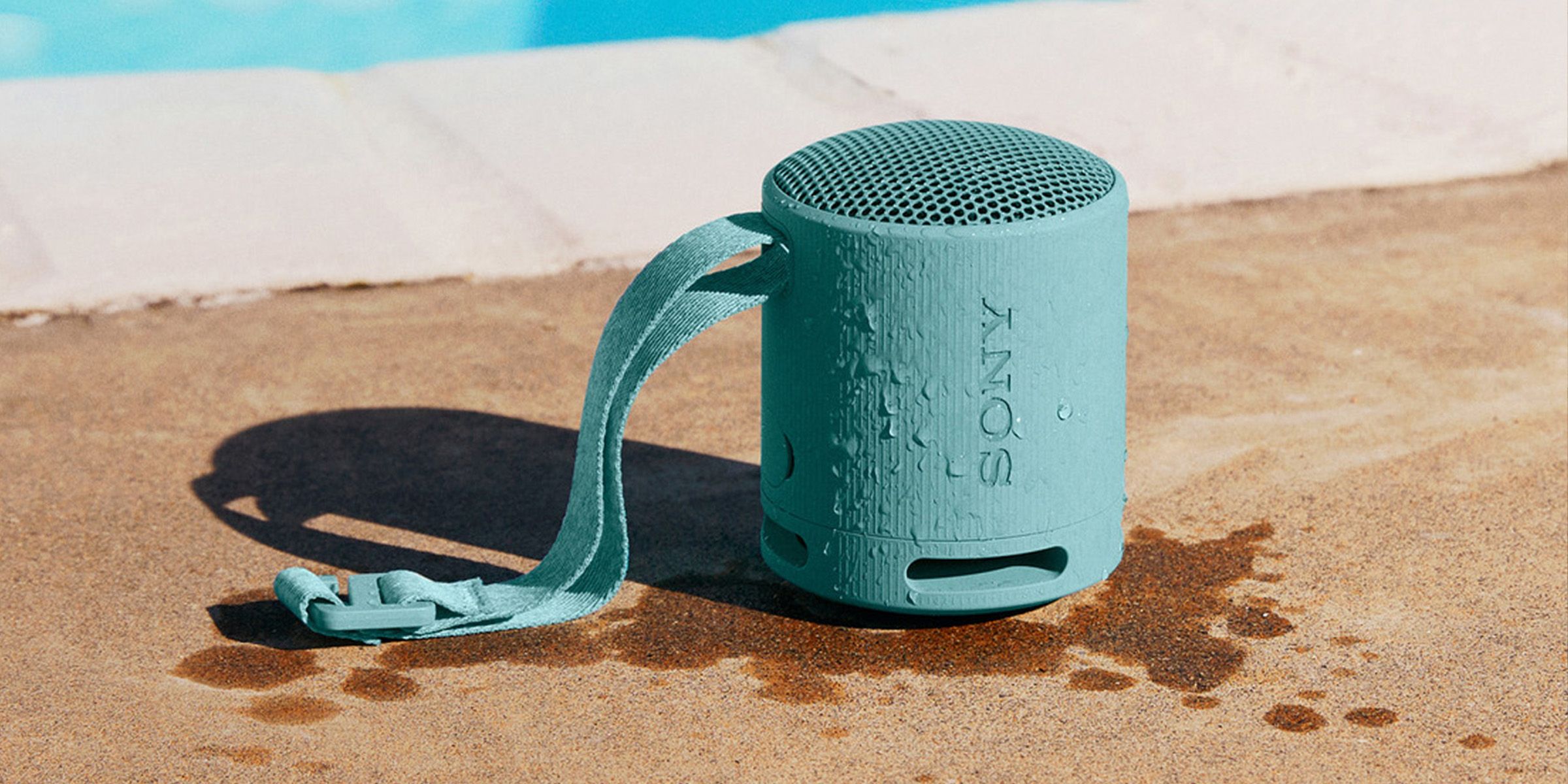 Sony speaker next to a pool, wet, showing water resistance