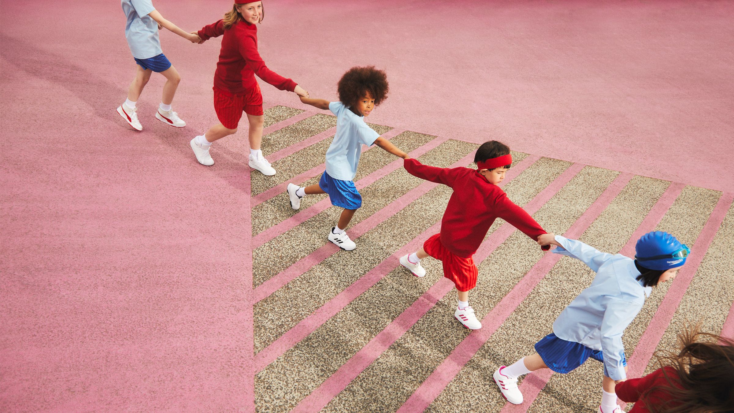 Image of a boy running across the playground with a periodic table in chalk on the floor