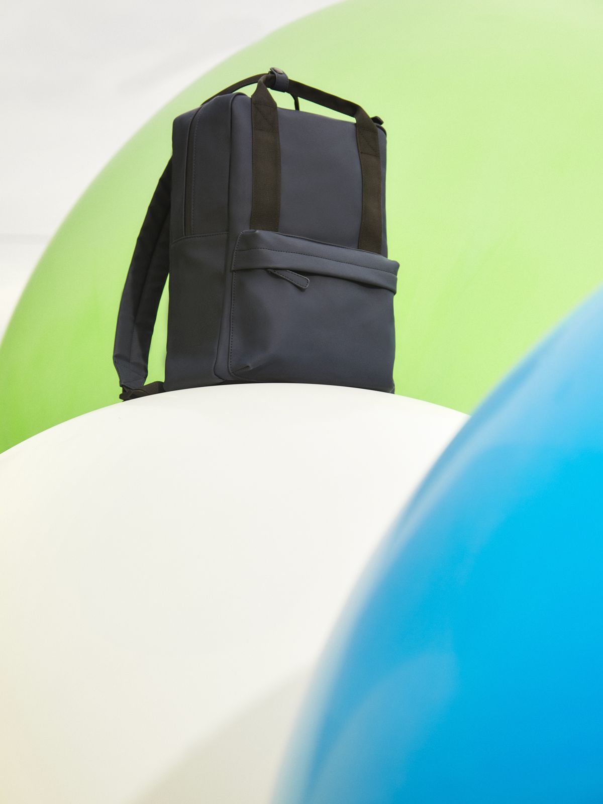 Image of a school bag on top of an inflatable ball