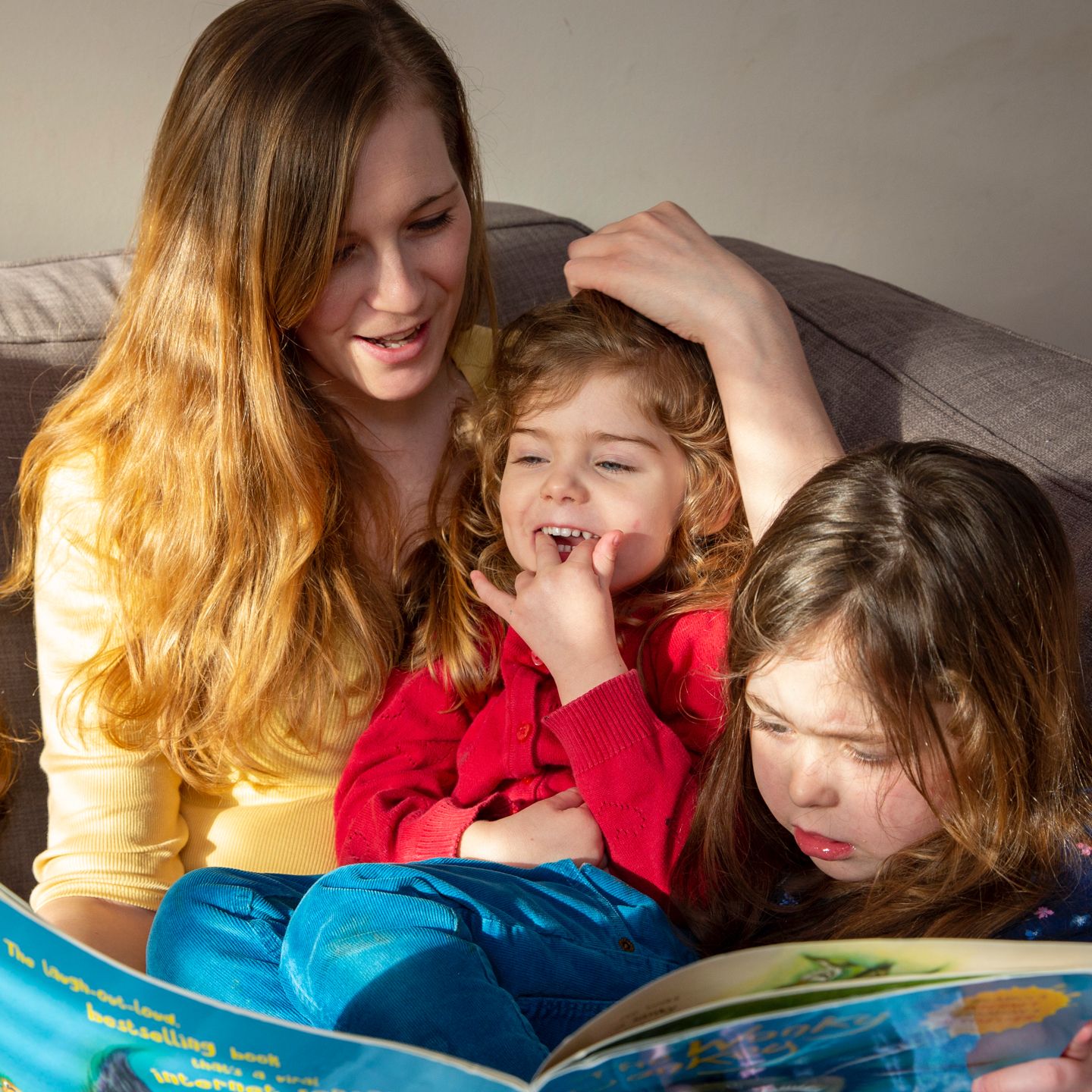  Give a Little Love - Home-Start - Mother and daughters reading a childrens book