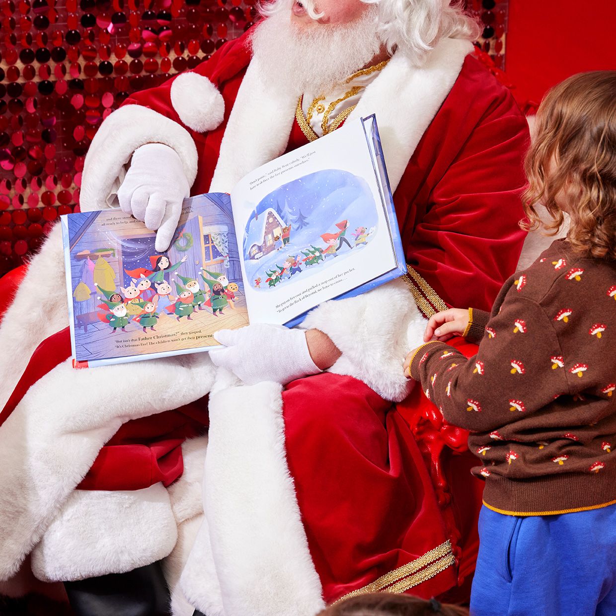 Image of a Santa reading a story to some children