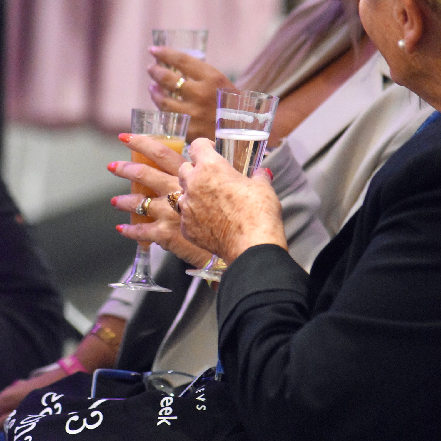 Image of people holding champayne glasses
