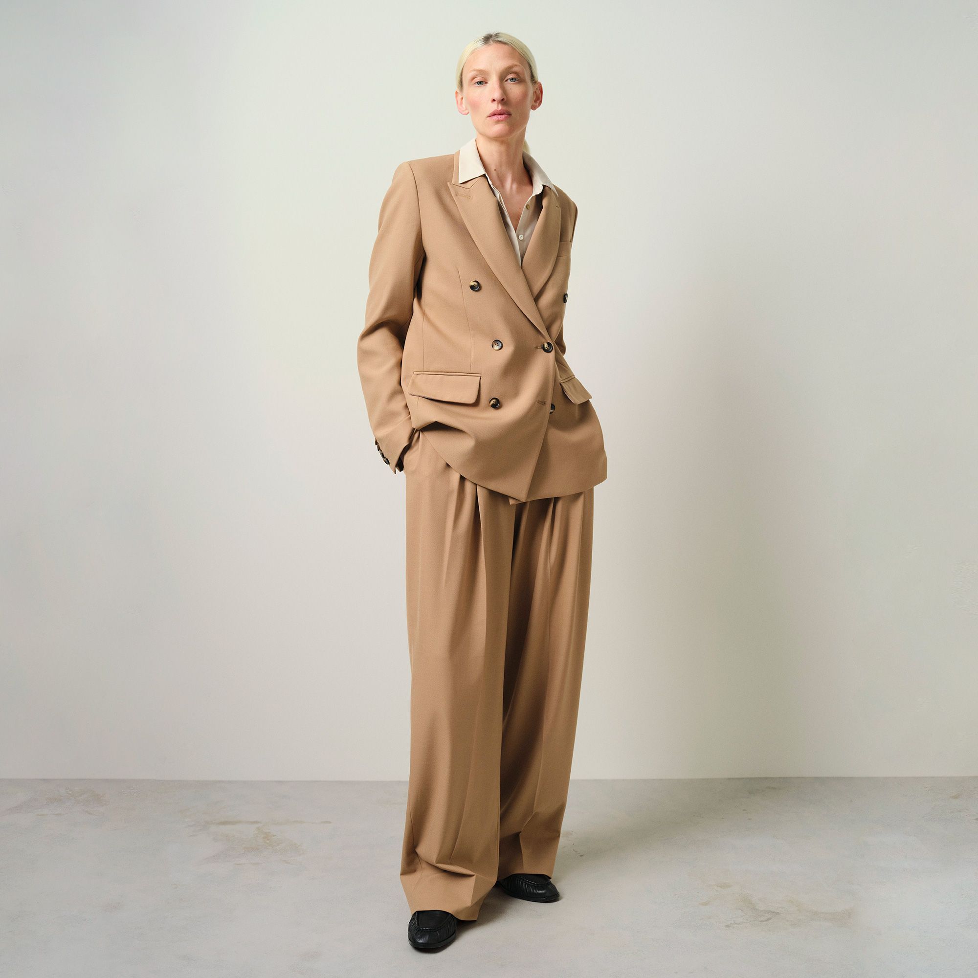 Image of a lady in a beige suit