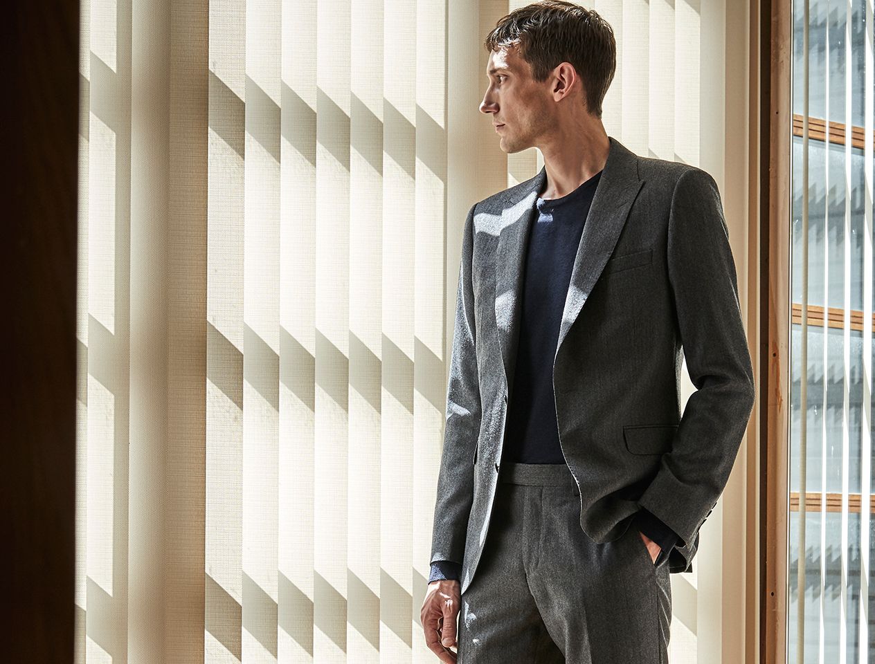 A model wearing a suit - one of the key pieces that make up a men's capsule wardrobe