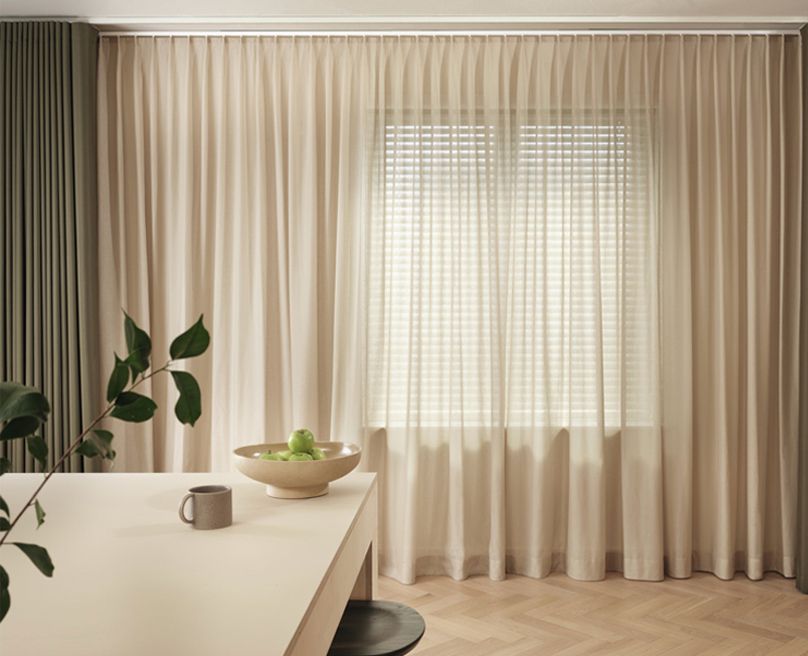 Image of a dining room with curtains in the background