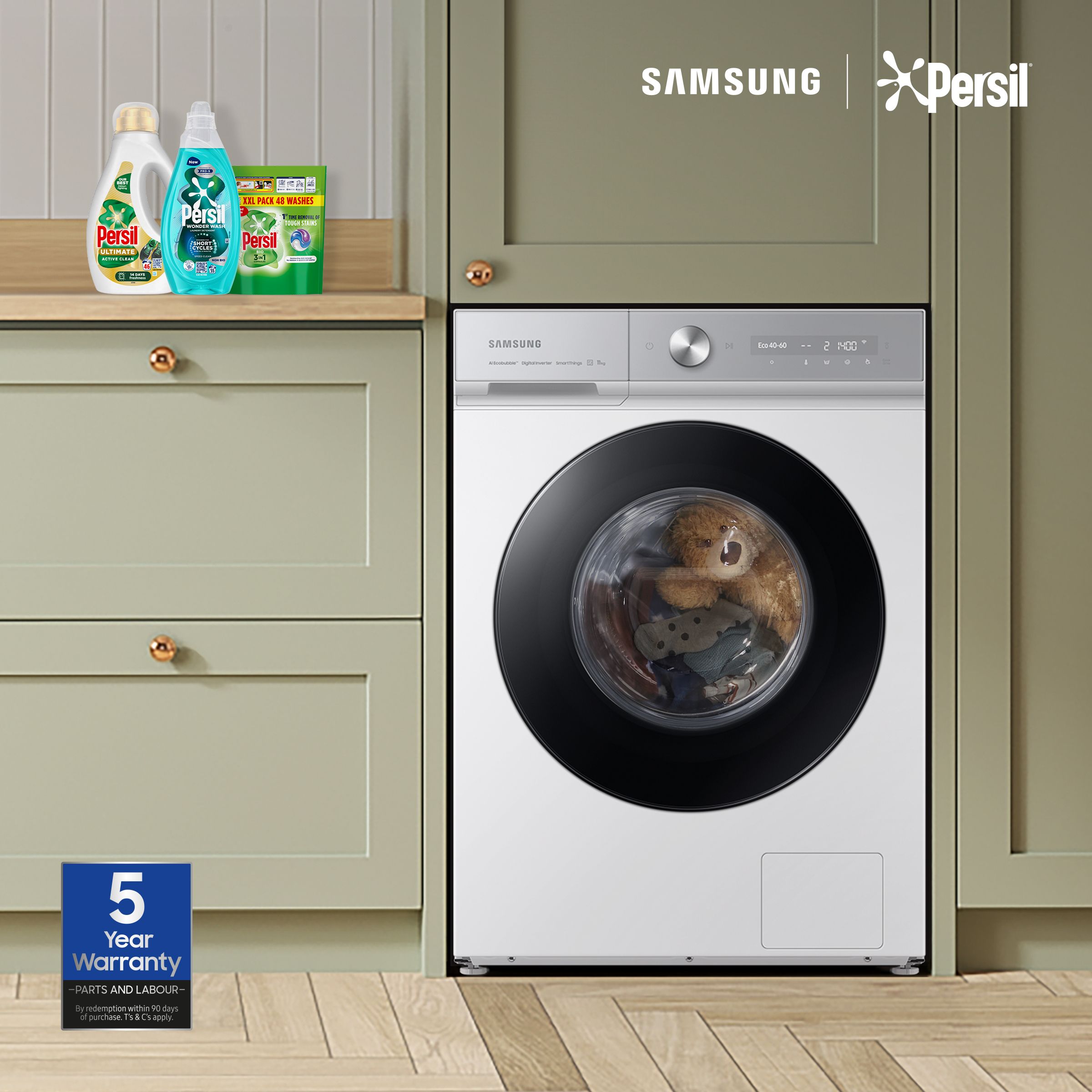 lifestyle shot of a washing machine in a kitchen with persil detergent on the countertop - Claim 6 months free Persil detergent