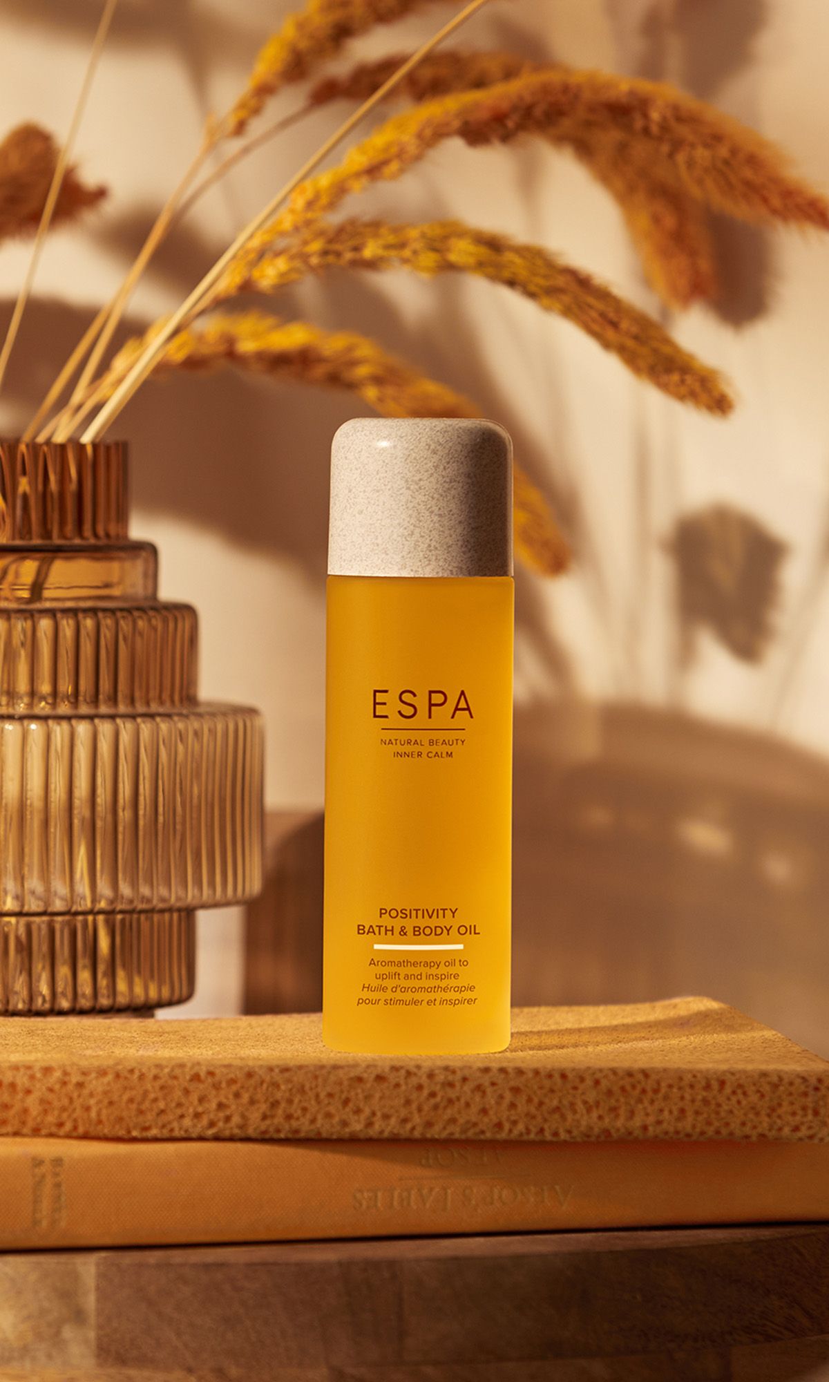 Espa bath and body oil product displayed on wooden bed-side table