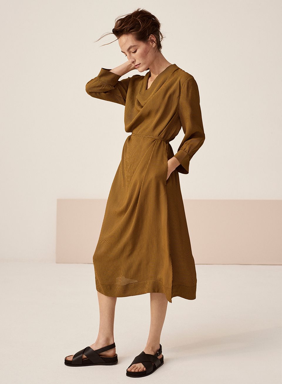 Model wearing a drape neck-waisted dress from Kin spring/summer 2020