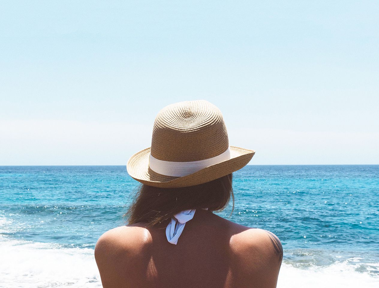 woman on a beach in a hat