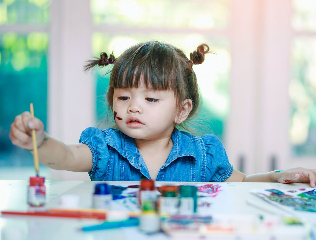 Child painting at nursery