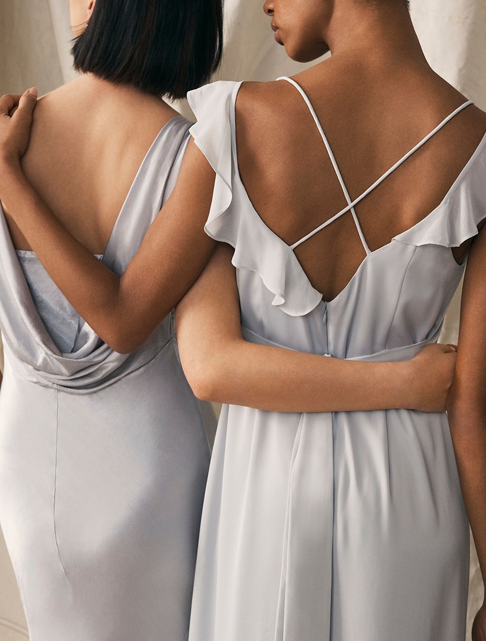 Two models from the back in bridesmaid dresses