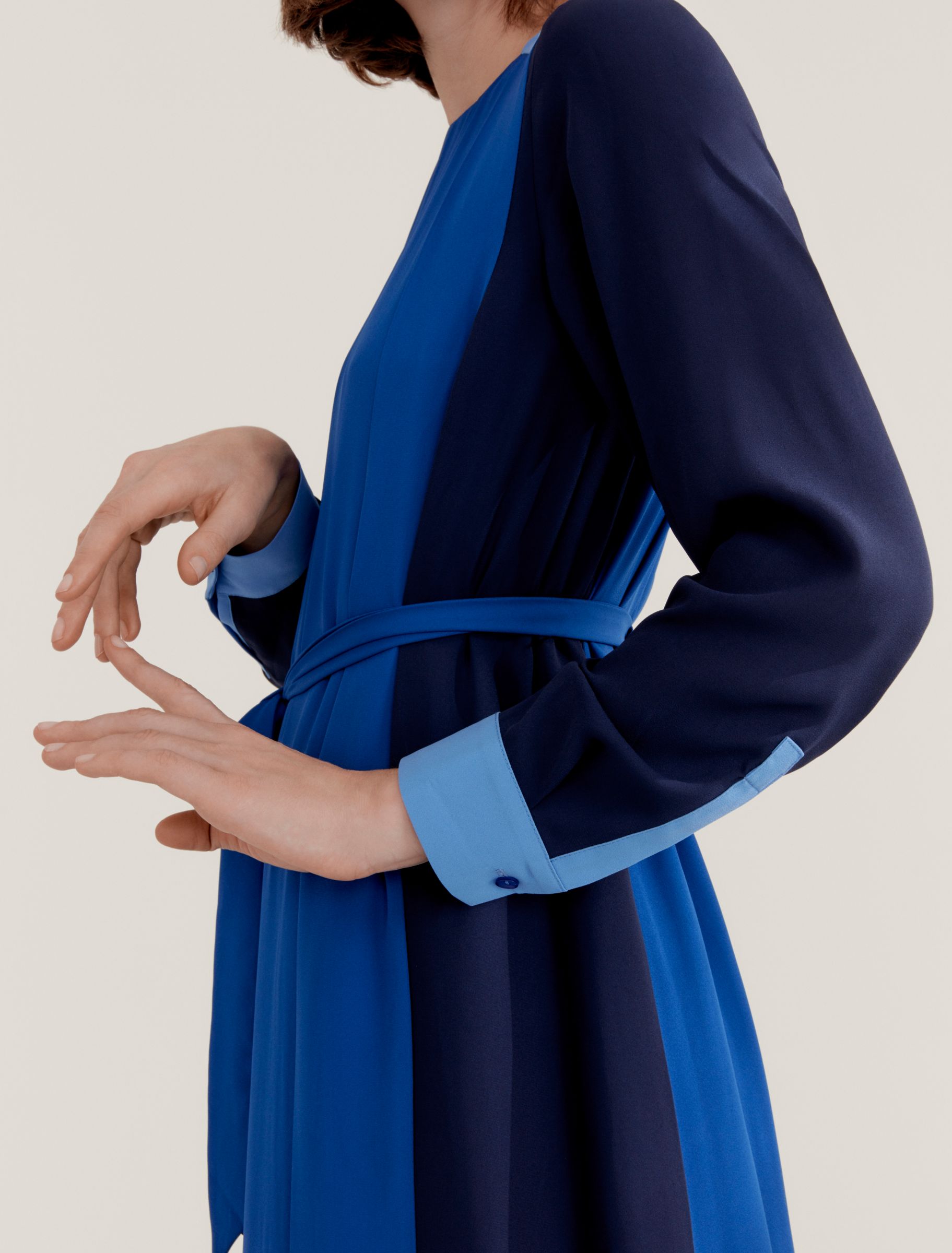 Woman in blue colour block dress