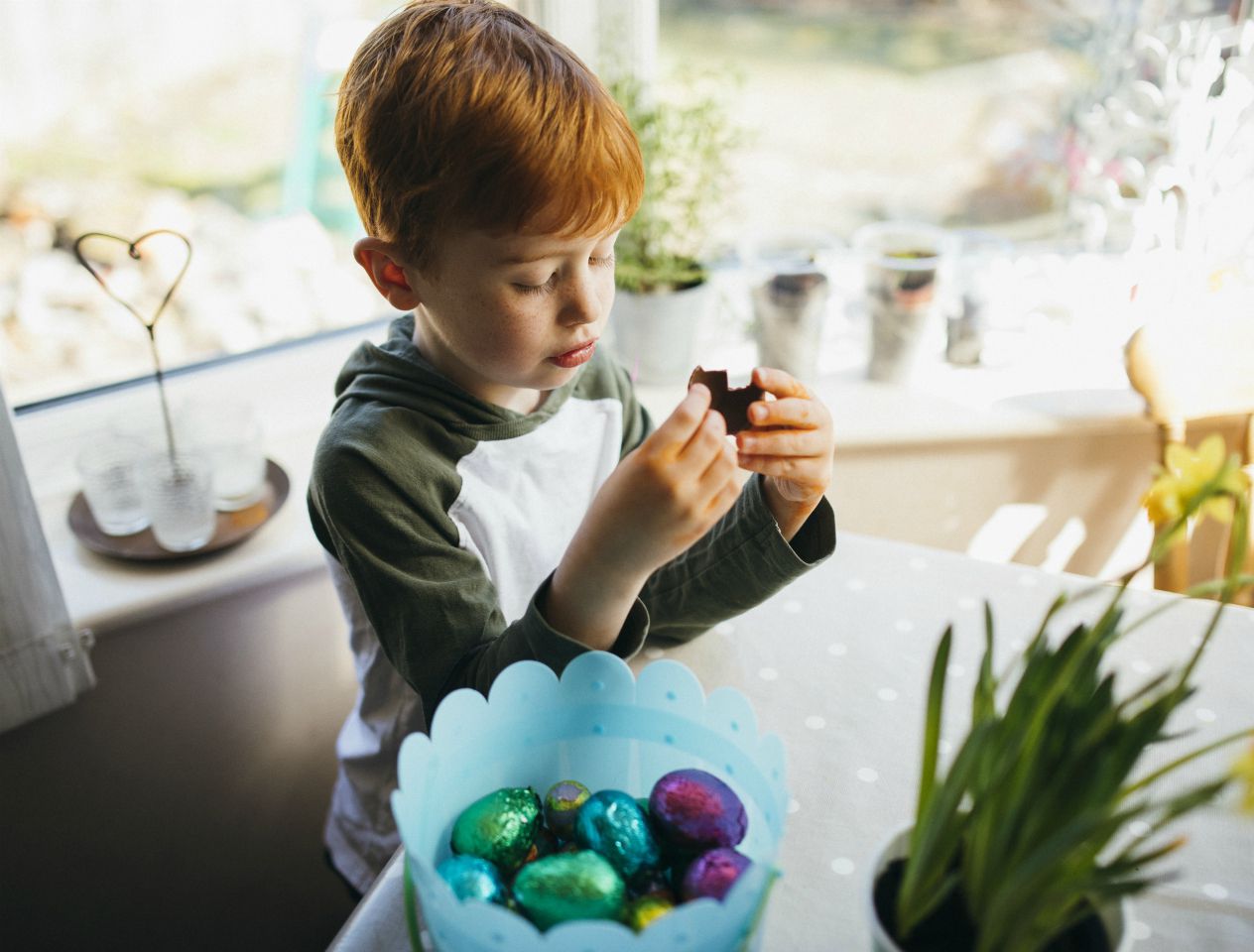 Boy at home with Easter eggs. Image by Getty.