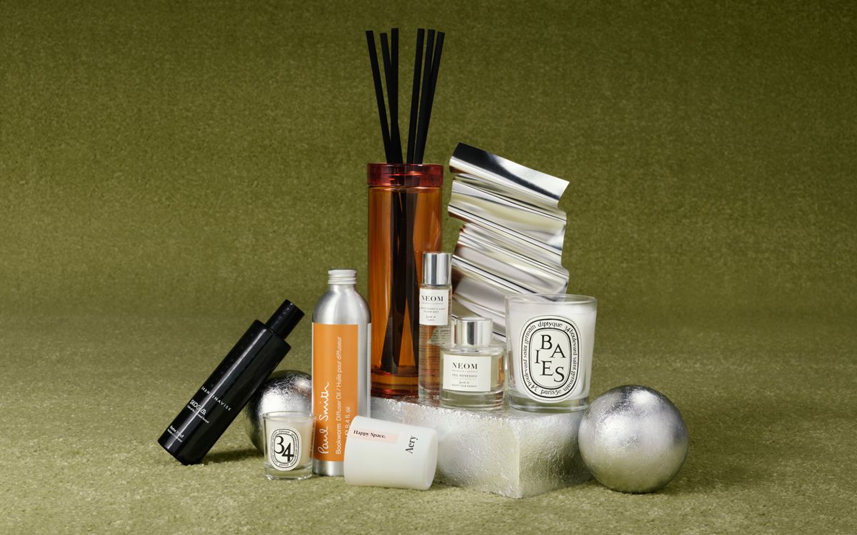 image of a collection of different candles and diffusers on a green background
