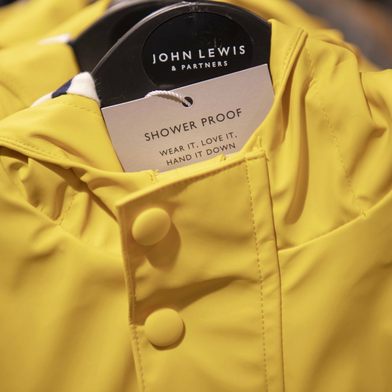 Yellow John Lewis & Partners kids' rain coat with re-use labelling